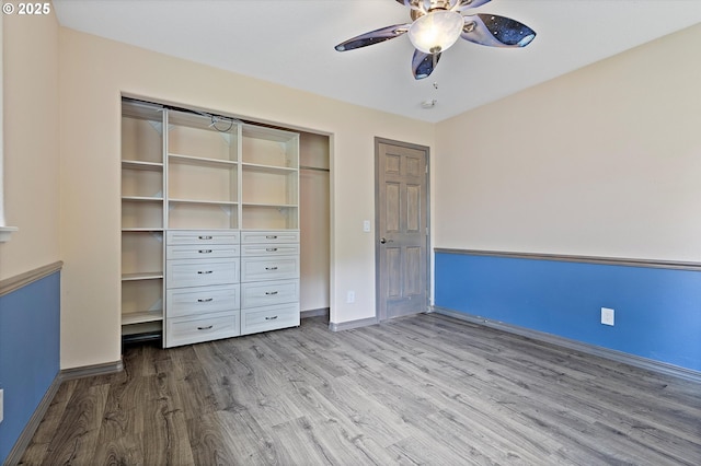 1012 E Foothills Dr, Newberg, OR 97132 - unfurnished bedroom featuring wood finished floors, a closet, and a ceiling fan