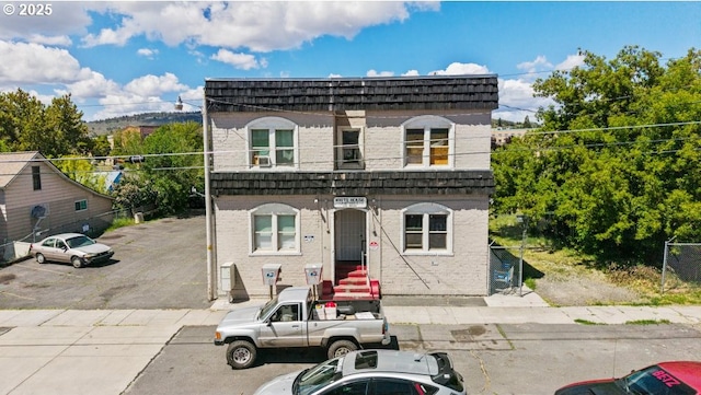 224 S Broad St, Klamath Falls, OR 97601 - view of front of house with uncovered parking, mansard roof, and brick siding