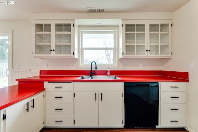 kitchen with visible vents, a healthy amount of sunlight, dishwasher, and a sink