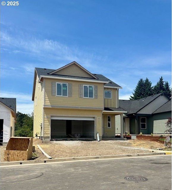 1707 N Millican Creek St, Lafayette, OR 97127 - view of front of house with an attached garage and board and batten siding