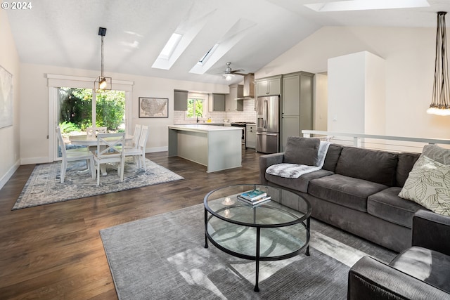 9636 SW Boones Ferry Rd, Portland, OR 97219 - living room with a skylight, lofted ceiling, dark wood finished floors, and baseboards