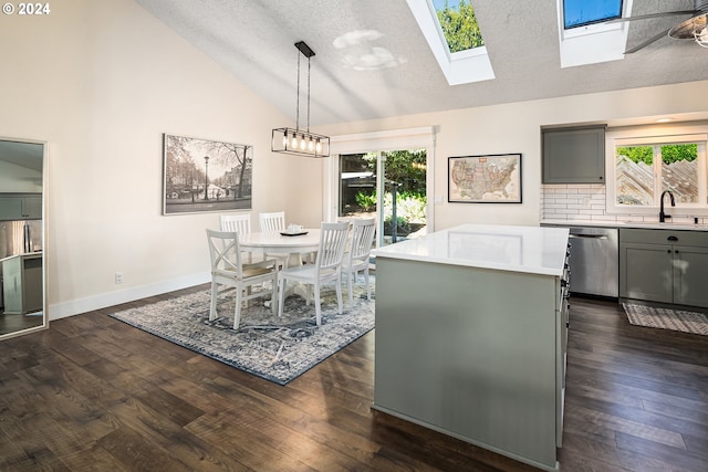 9636 SW Boones Ferry Rd, Portland, OR 97219 - dining area featuring vaulted ceiling, healthy amount of natural light, a skylight, dark wood-style floors, and baseboards
