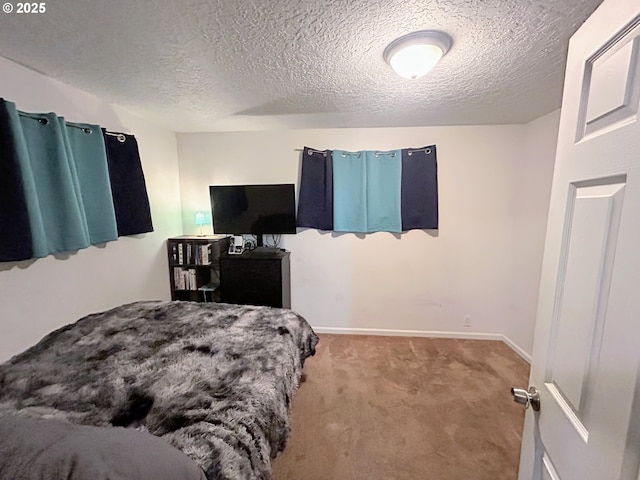 bedroom with a textured ceiling and carpet