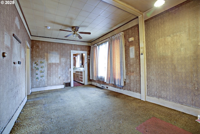 spare room featuring ornamental molding, carpet floors, and ceiling fan