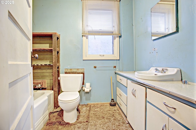 bathroom featuring vanity, a tub to relax in, a wealth of natural light, and toilet