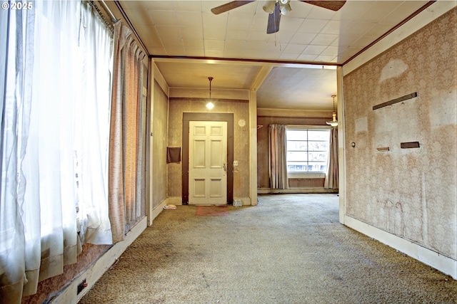 unfurnished room with ceiling fan, ornamental molding, and carpet