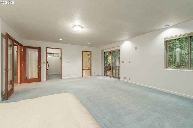 carpeted empty room featuring a textured ceiling