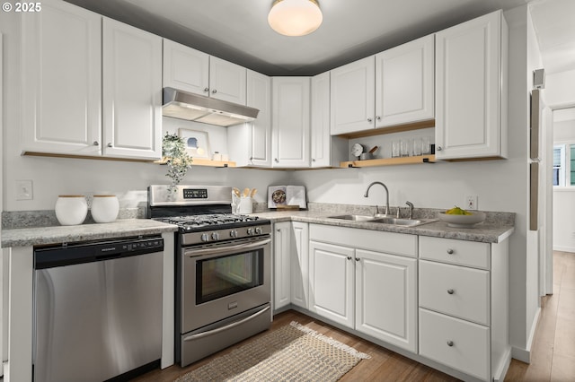 kitchen featuring white cabinetry, stainless steel appliances, sink, and wood-type flooring