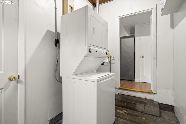 washroom featuring stacked washing maching and dryer