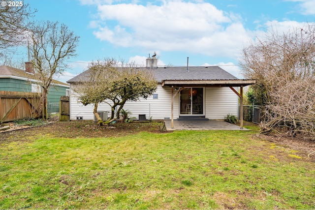 rear view of house featuring a patio and a yard