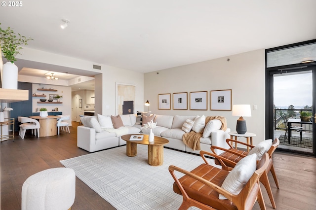 living room with a chandelier and hardwood / wood-style flooring