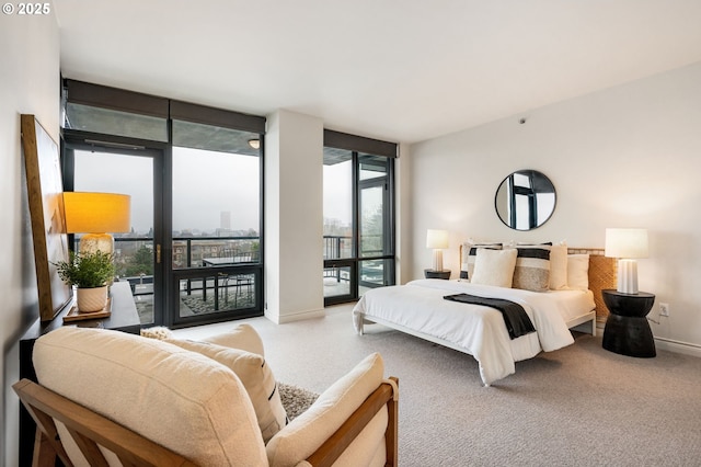 bedroom featuring expansive windows, carpet flooring, and access to exterior