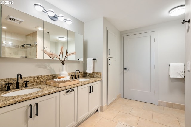 bathroom with tile patterned floors and vanity