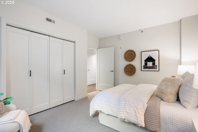 bedroom with light carpet and a closet