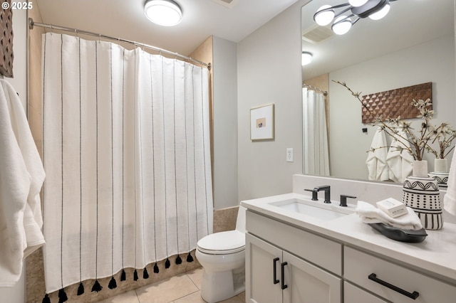 bathroom with tile patterned floors, vanity, and toilet