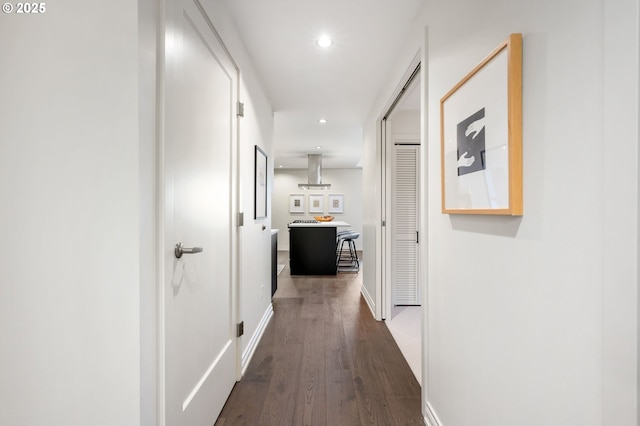 hallway with dark hardwood / wood-style flooring