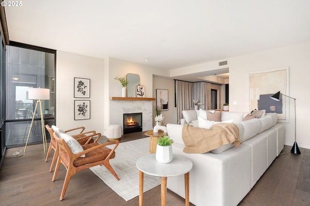 living room with dark wood-type flooring and a fireplace