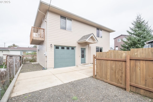 view of front of house with a garage and a balcony