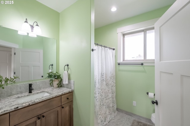 bathroom with toilet, a shower with shower curtain, backsplash, tile patterned floors, and vanity