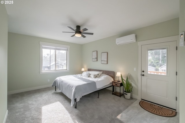 carpeted bedroom featuring ceiling fan and a wall mounted AC