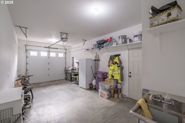 garage with a garage door opener and white refrigerator