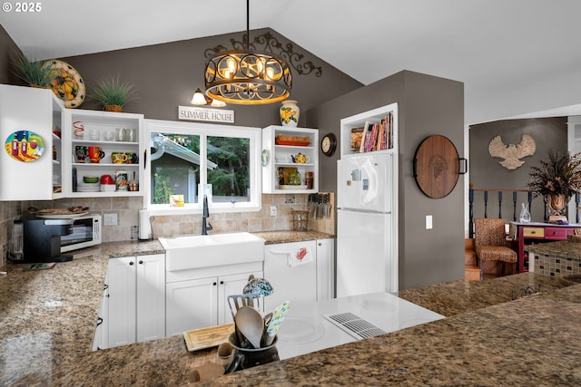 6027 View Loop, Florence, OR 97439 - kitchen featuring freestanding refrigerator, open shelves, a chandelier, stone countertops, and backsplash