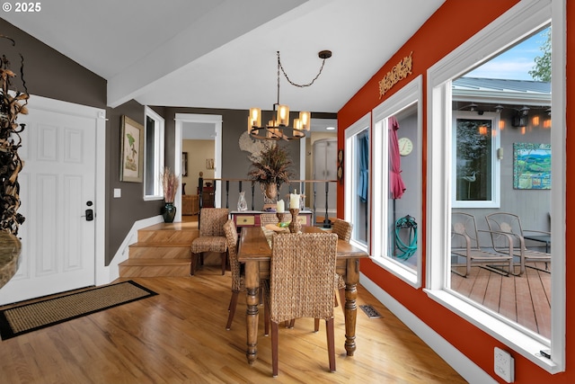 6027 View Loop, Florence, OR 97439 - dining room with a chandelier, wood finished floors, and plenty of natural light