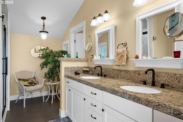 6027 View Loop, Florence, OR 97439 - bathroom with lofted ceiling, tile patterned floors, and double vanity