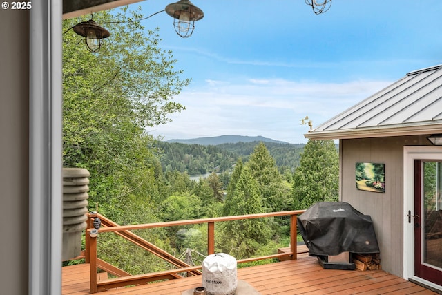 6027 View Loop, Florence, OR 97439 - deck with a wooded view, a mountain view, and a grill