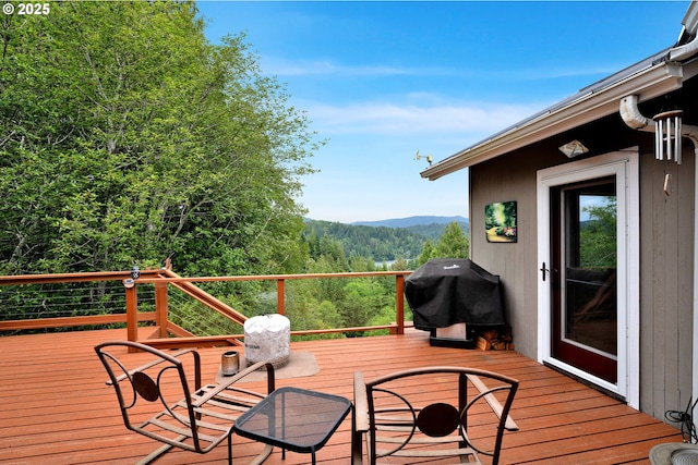 6027 View Loop, Florence, OR 97439 - wooden terrace featuring area for grilling, a mountain view, and a wooded view