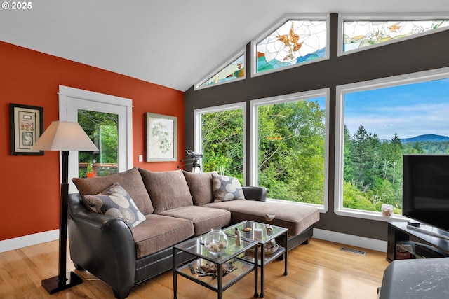 6027 View Loop, Florence, OR 97439 - living area with light wood-style flooring and high vaulted ceiling