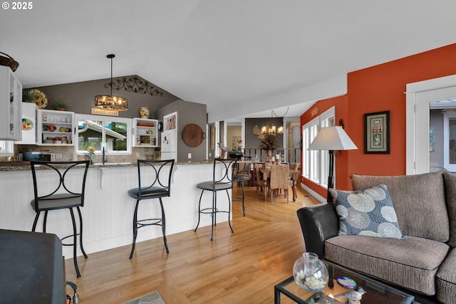 6027 View Loop, Florence, OR 97439 - living area with a chandelier, light wood-type flooring, and lofted ceiling