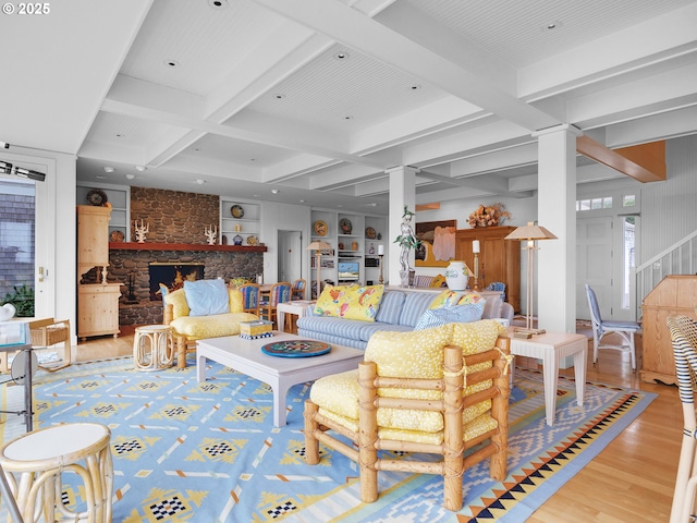 766 Neacoxie Blvd, Gearhart, OR 97138 - living room featuring light wood finished floors, coffered ceiling, beam ceiling, a stone fireplace, and stairs