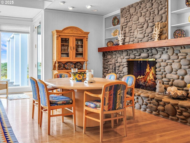 766 Neacoxie Blvd, Gearhart, OR 97138 - dining room featuring wood finished floors, crown molding, and a fireplace