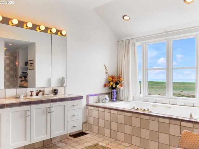 766 Neacoxie Blvd, Gearhart, OR 97138 - bathroom featuring vanity, lofted ceiling, a garden tub, recessed lighting, and tile patterned flooring