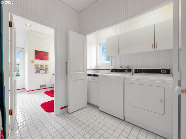 766 Neacoxie Blvd, Gearhart, OR 97138 - laundry area featuring cabinet space, independent washer and dryer, and light tile patterned floors