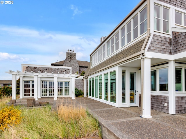 766 Neacoxie Blvd, Gearhart, OR 97138 - back of house with a pergola and roof with shingles
