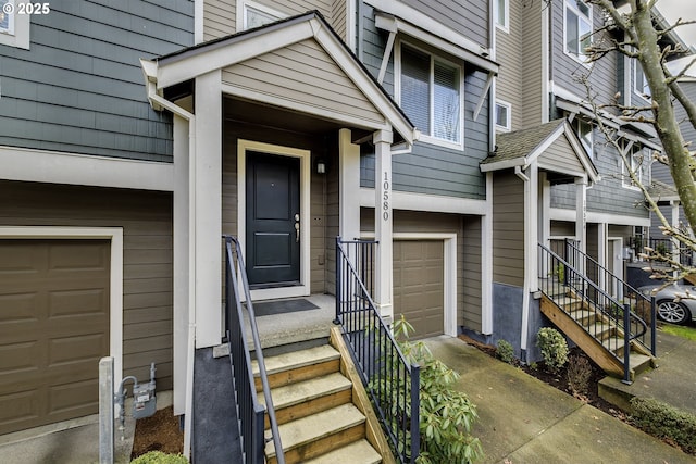 doorway to property with a garage