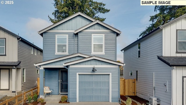 view of front of home with an attached garage, fence, and board and batten siding