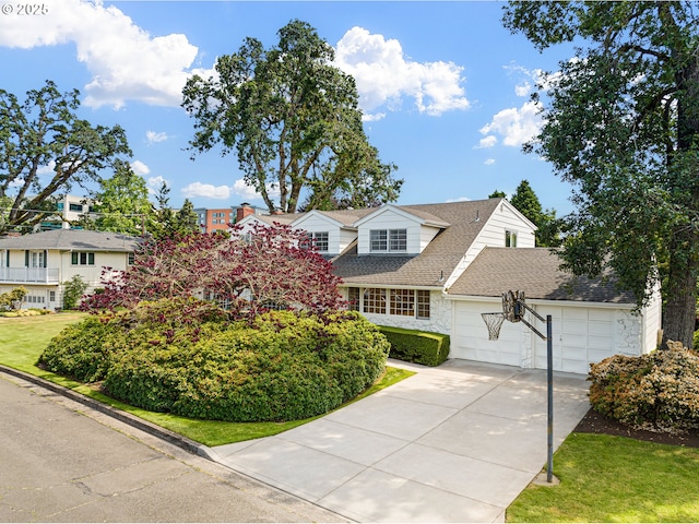 2160 Oakmont Way, Eugene, OR 97401 - view of front facade with concrete driveway, a garage, roof with shingles, stone siding, and a residential view