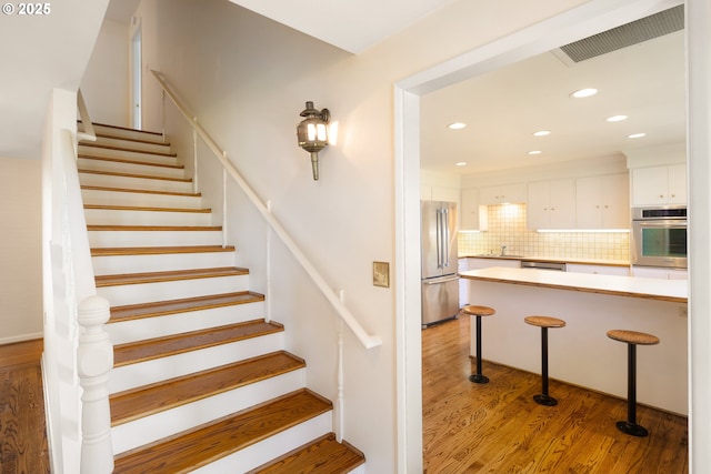 2160 Oakmont Way, Eugene, OR 97401 - staircase featuring wood finished floors and recessed lighting