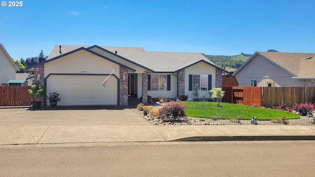 1234 E Fourth Ave, Sutherlin, OR 97479 - ranch-style house with driveway and an attached garage