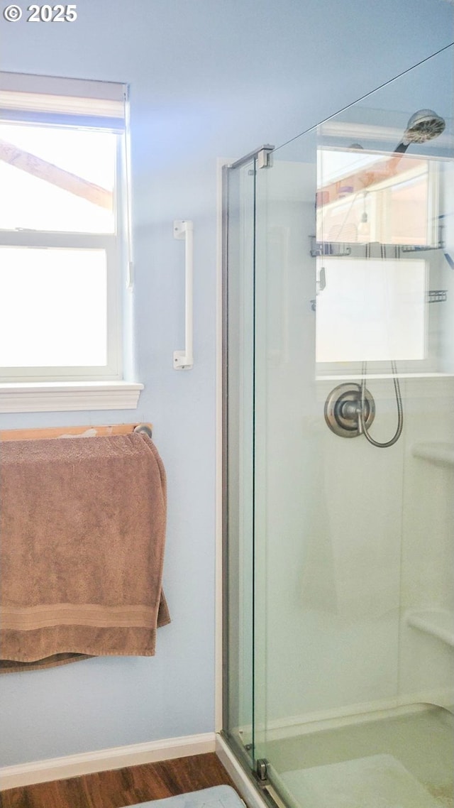 1234 E Fourth Ave, Sutherlin, OR 97479 - bathroom featuring a shower stall, wood finished floors, and baseboards
