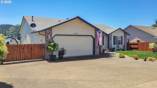 1234 E Fourth Ave, Sutherlin, OR 97479 - view of front of house with a garage, driveway, brick siding, and a shingled roof