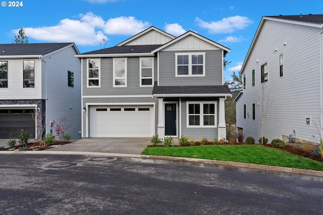 view of front of property featuring a garage and a front lawn