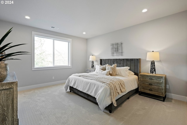 bedroom featuring light carpet