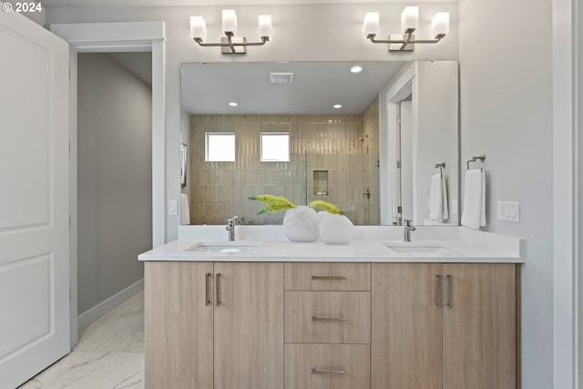 bathroom with tiled shower and vanity