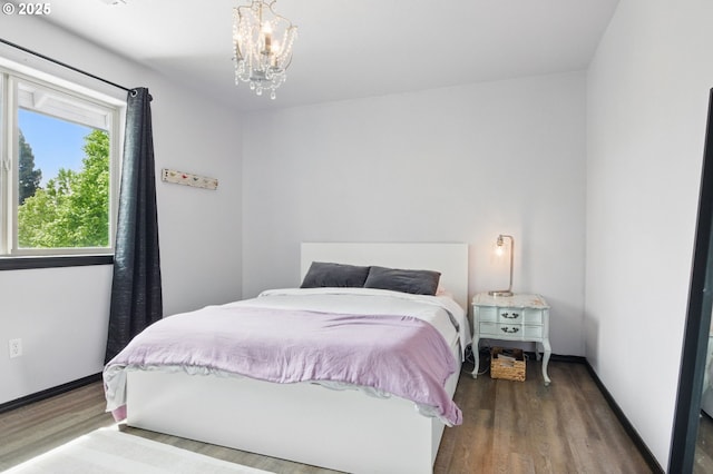 1146 SE Millright Ave, Mcminnville, OR 97128 - bedroom with wood finished floors, a chandelier, and baseboards