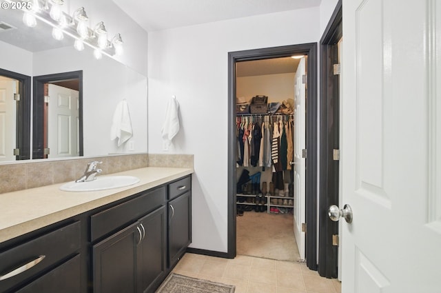 1146 SE Millright Ave, Mcminnville, OR 97128 - bathroom featuring vanity, a spacious closet, and tile patterned floors