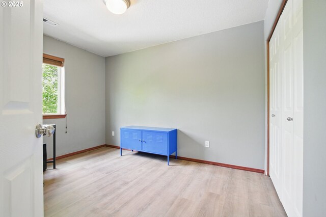 1146 SE Millright Ave, Mcminnville, OR 97128 - unfurnished bedroom with light wood-style flooring, a closet, and baseboards